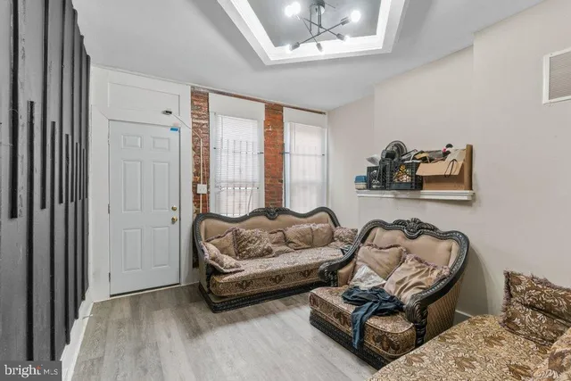 a living room with furniture and a chandelier