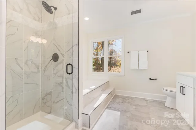 a bathroom with a bathtub and shower