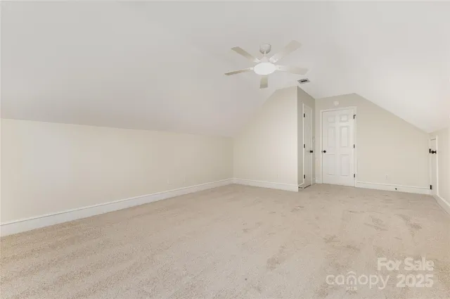 a view of a kitchen with a sink and a chandelier fan