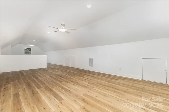 a bathroom with a granite countertop toilet sink and mirror