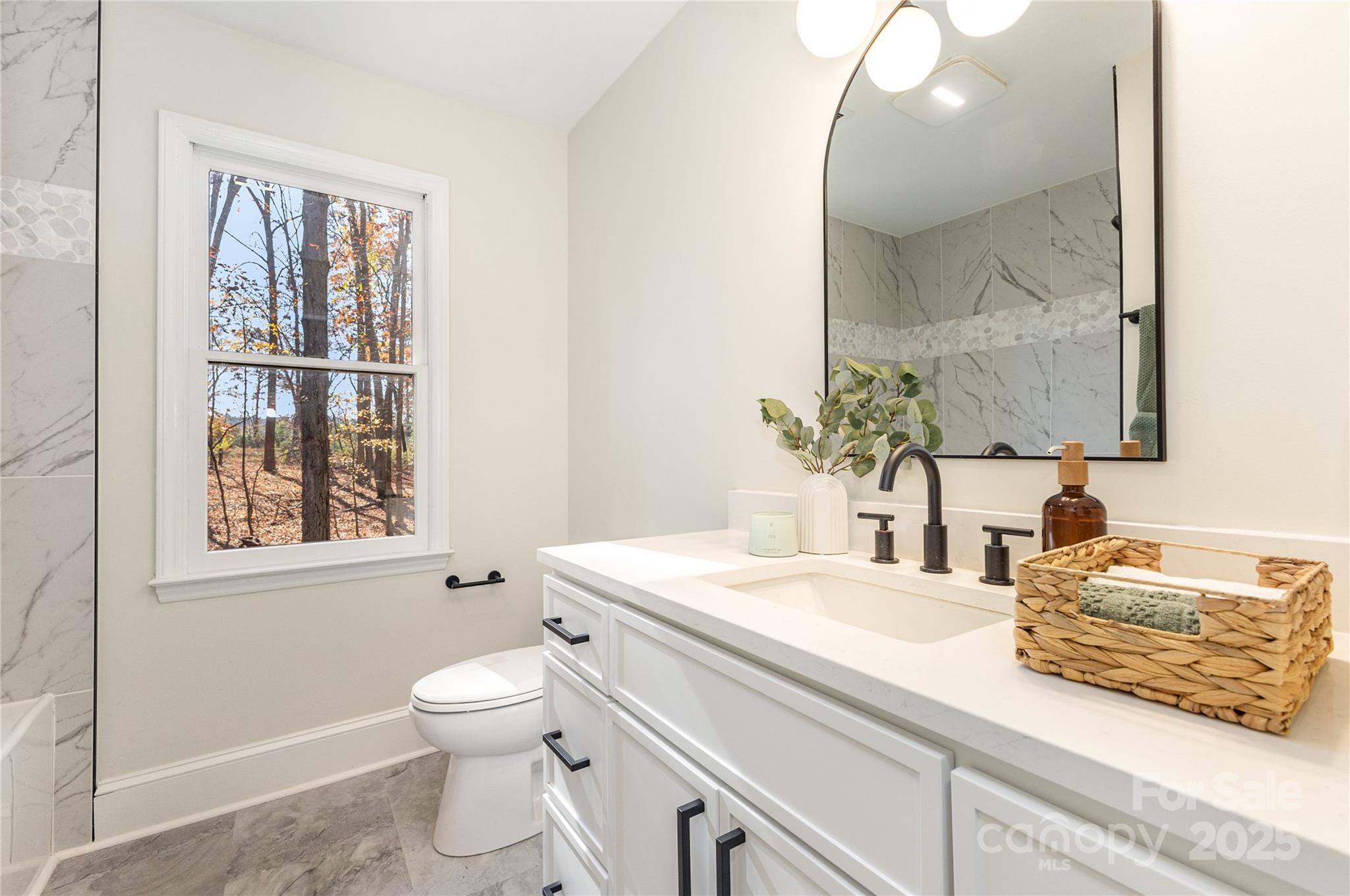 3335 Carnegie Lane Matthews, NC 28105 - Photo 22 of 31 a bathroom with a granite countertop toilet sink and mirror