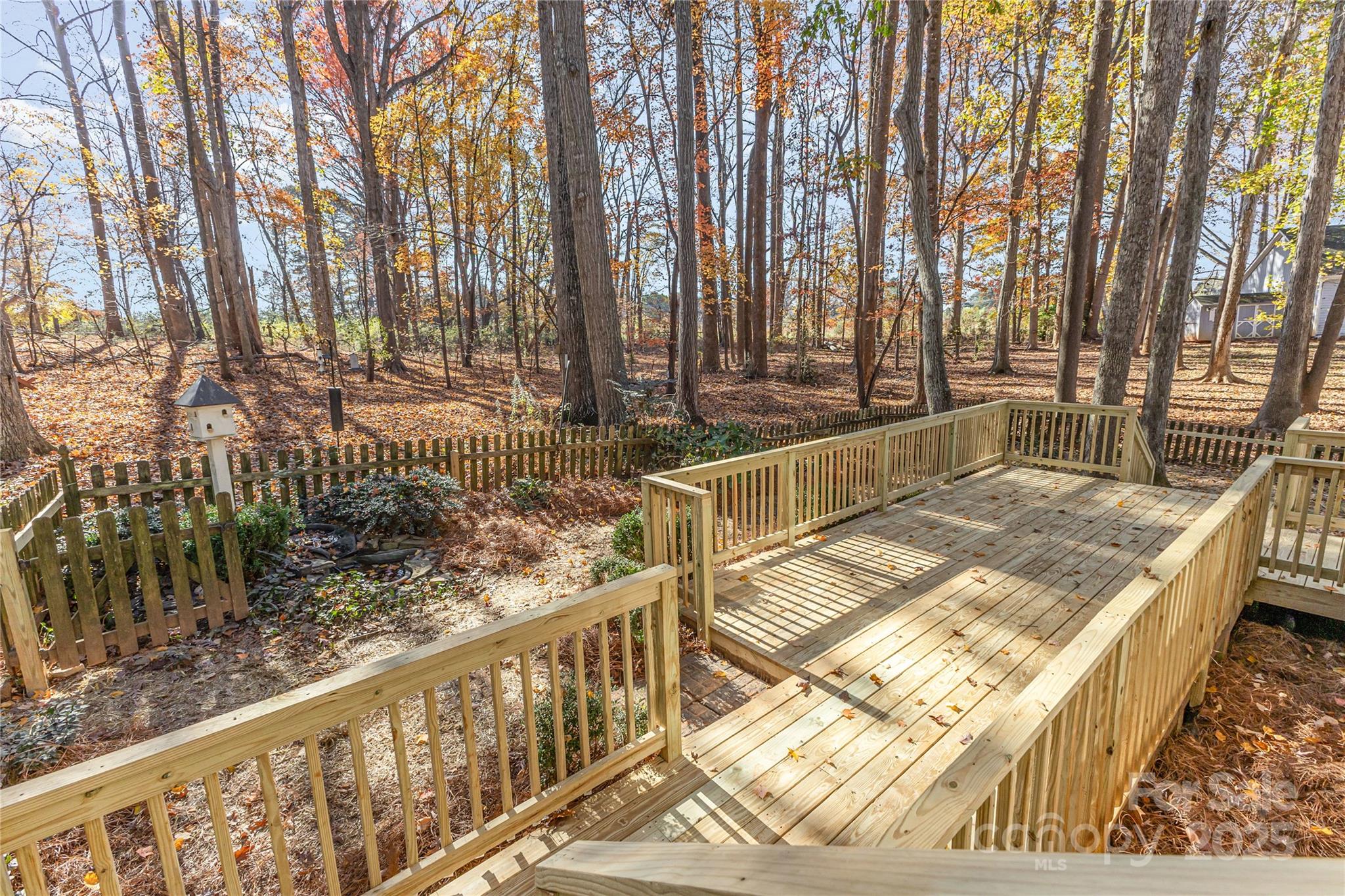 3335 Carnegie Lane Matthews, NC 28105 - Photo 29 of 31 a view of backyard with wooden fence and large trees
