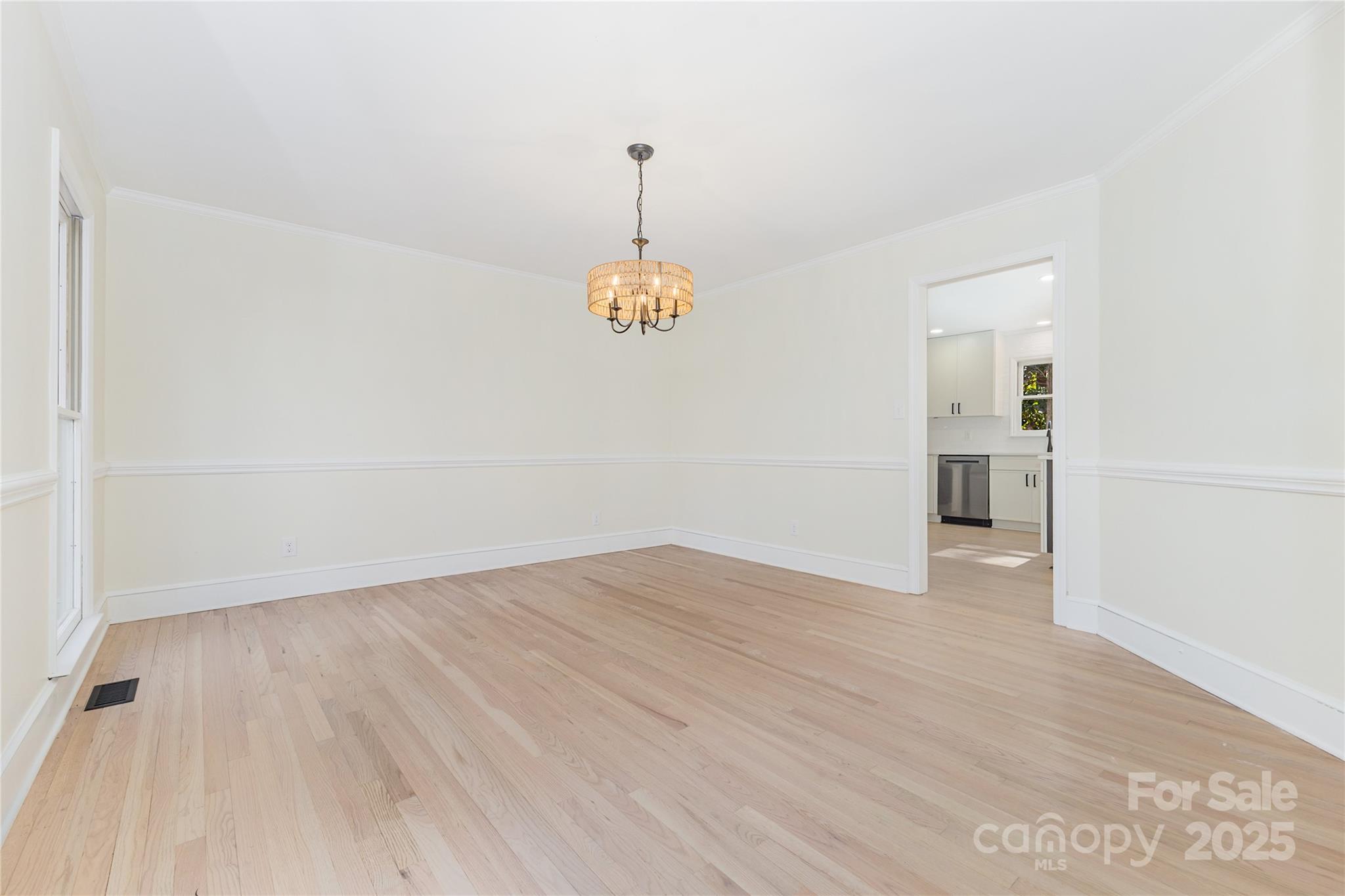 3335 Carnegie Lane Matthews, NC 28105 - Photo 10 of 31 a view of an empty room with window and wooden floor