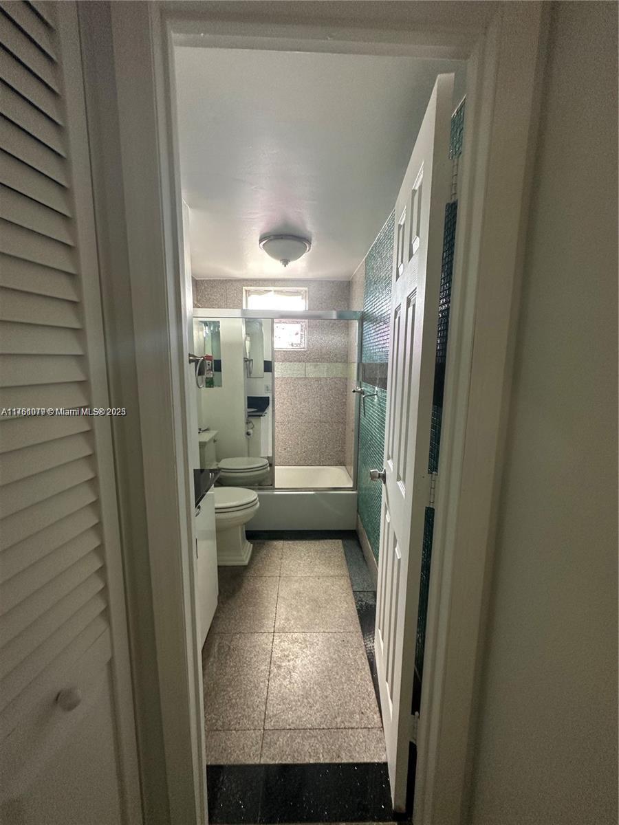 1100 Northeast 1st Court, Unit 105 Hallandale Beach, FL 33009 - Photo 6 of 13 a bathroom with a sink and toilet