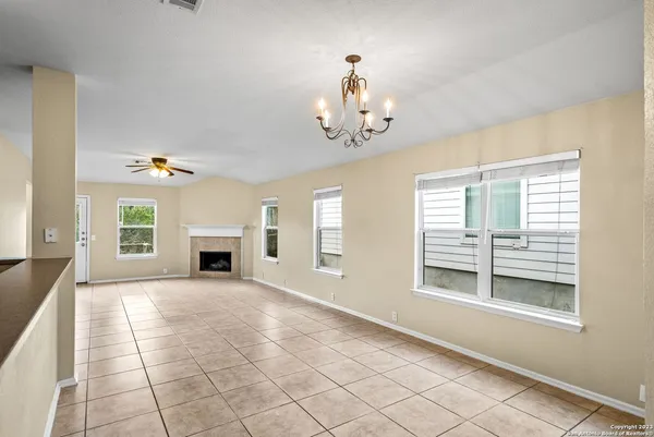 a view of an empty room with a fireplace and a window