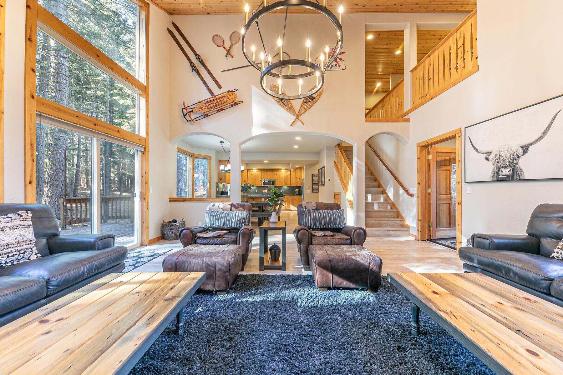 a living room with furniture chandelier and a large window