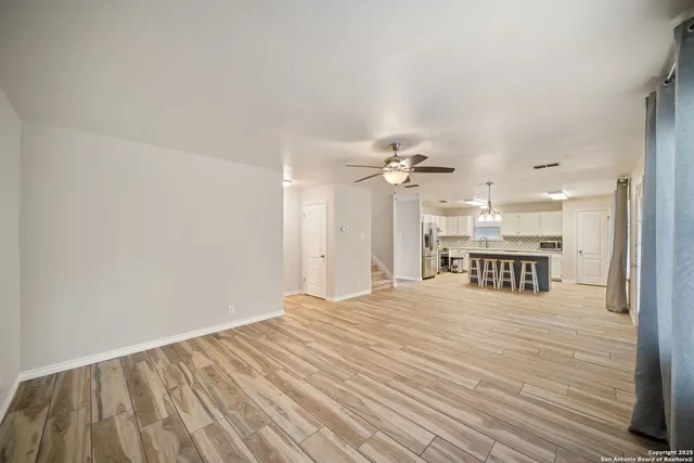a view of a room with a ceiling fan