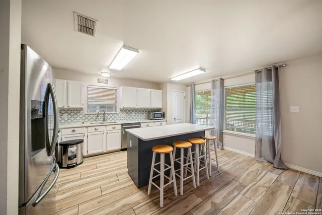 a kitchen with stainless steel appliances granite countertop a stove and a refrigerator