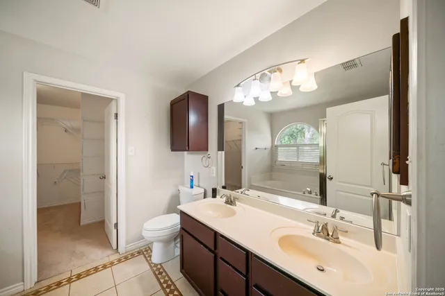 a bathroom with a sink double vanity and a mirror