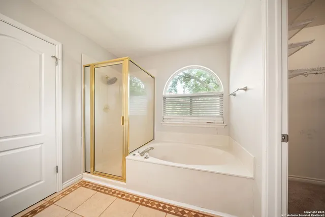a view of bathroom with bathtub and shower
