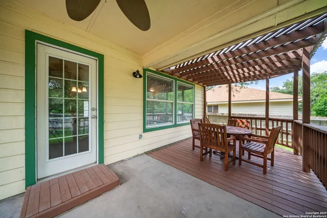 a view of a patio with table and chairs