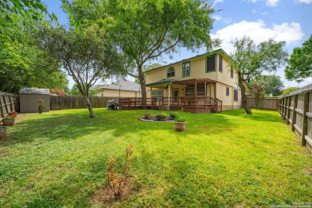 a view of a house with a yard and sitting area