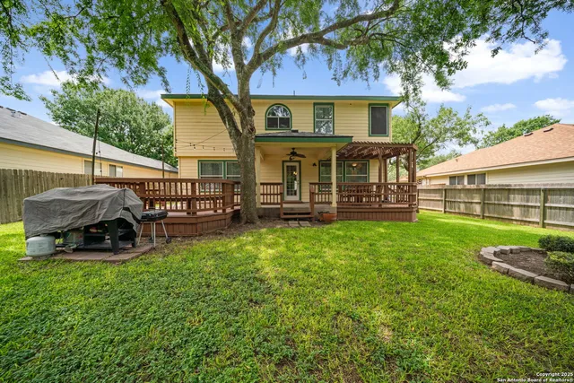 a view of a house with backyard and porch