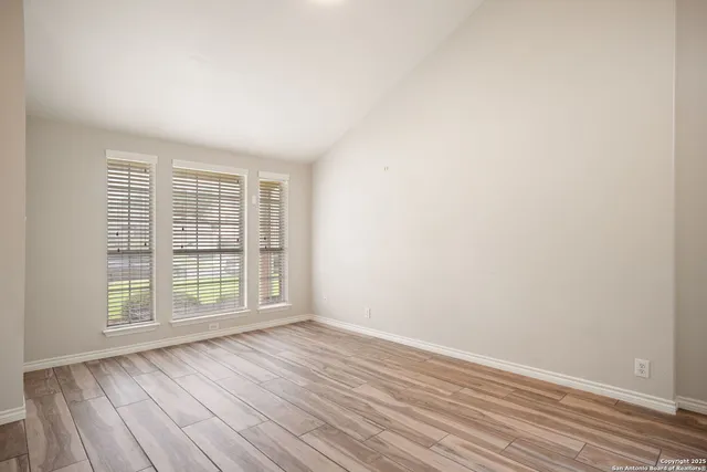 wooden floor in an empty room with a window