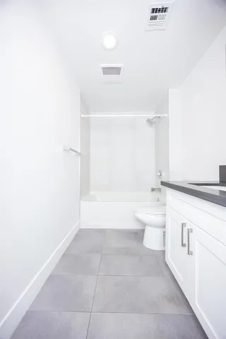 a bathroom with a bathtub sink vanity and toilet