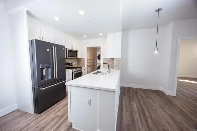 a kitchen with stainless steel appliances a refrigerator and a sink
