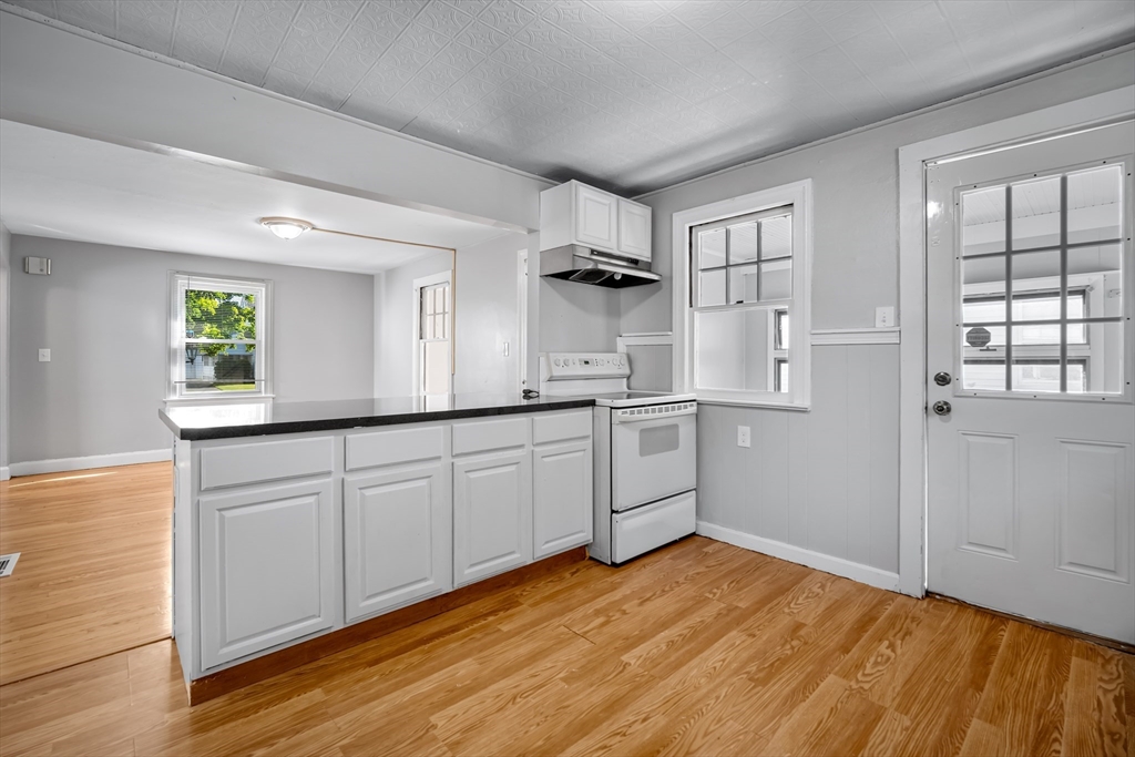216 Windemere Street Springfield, MA 01104 - Photo 3 of 35 a kitchen with white cabinets and wooden floors