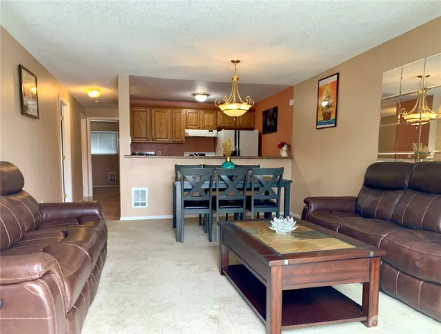 a living room with furniture and a chandelier