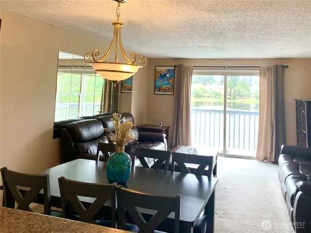 a view of a dining room with furniture window and outside view