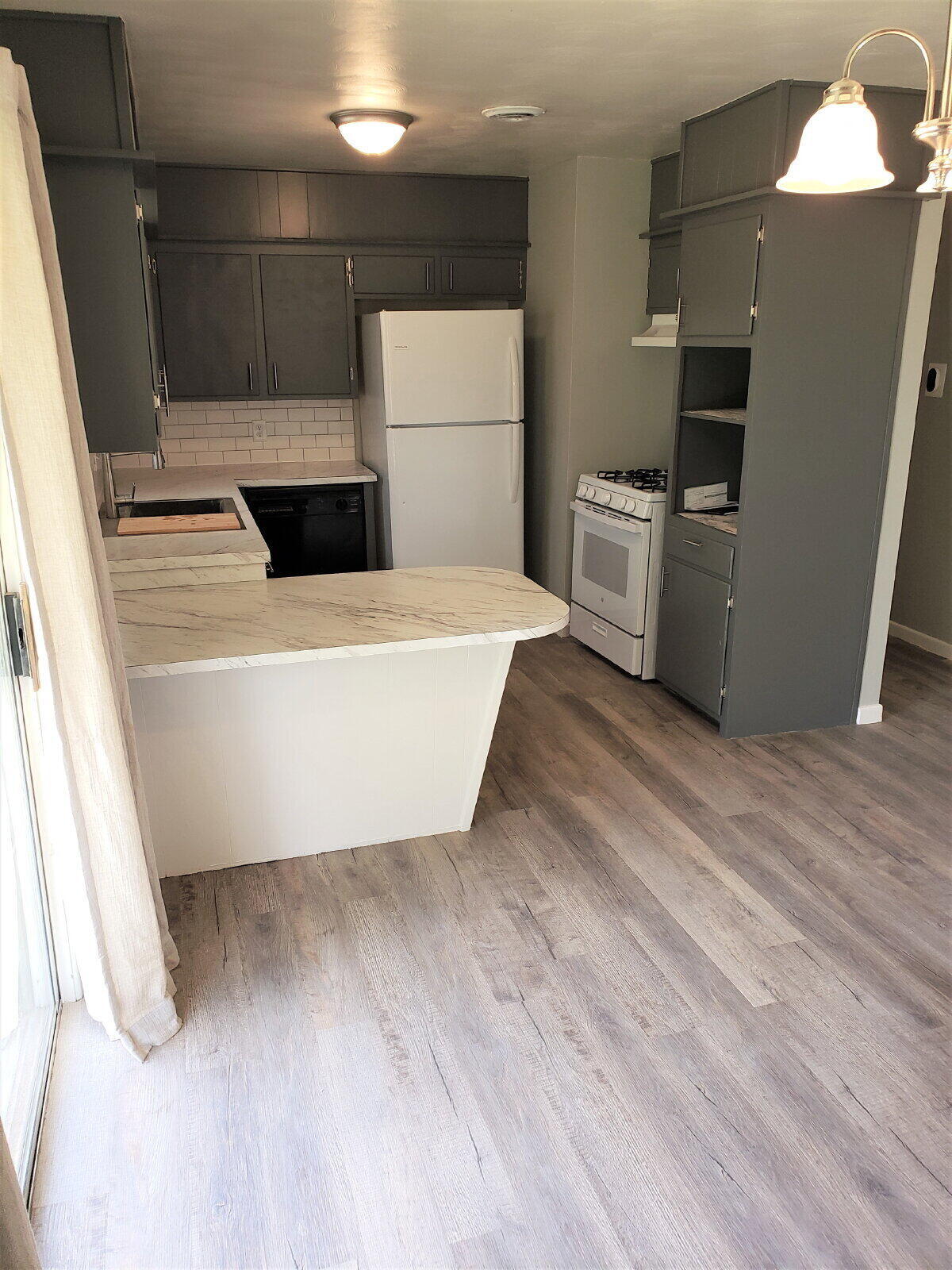 4906 6th Street Lubbock, TX 79416 - Photo 17 of 24 a view of a refrigerator in kitchen and an empty room