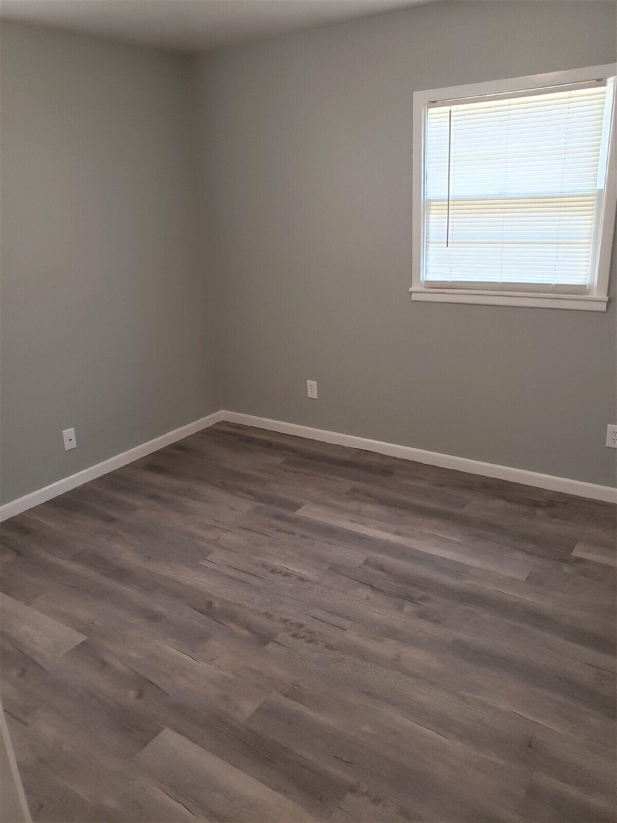4906 6th Street Lubbock, TX 79416 - Photo 22 of 24 a view of an empty room with wooden floor and a window