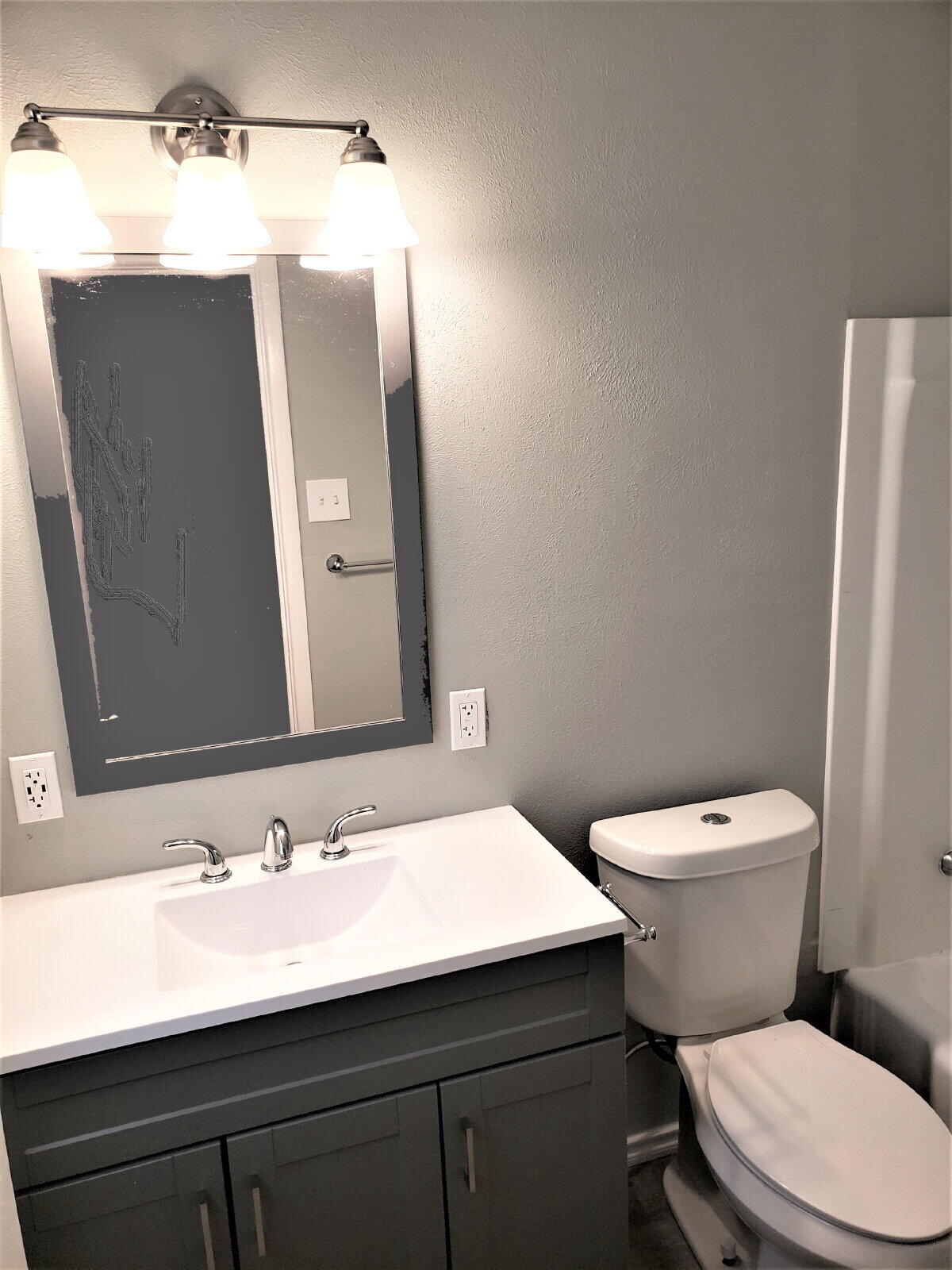 4906 6th Street Lubbock, TX 79416 - Photo 24 of 24 a bathroom with a toilet a sink and mirror