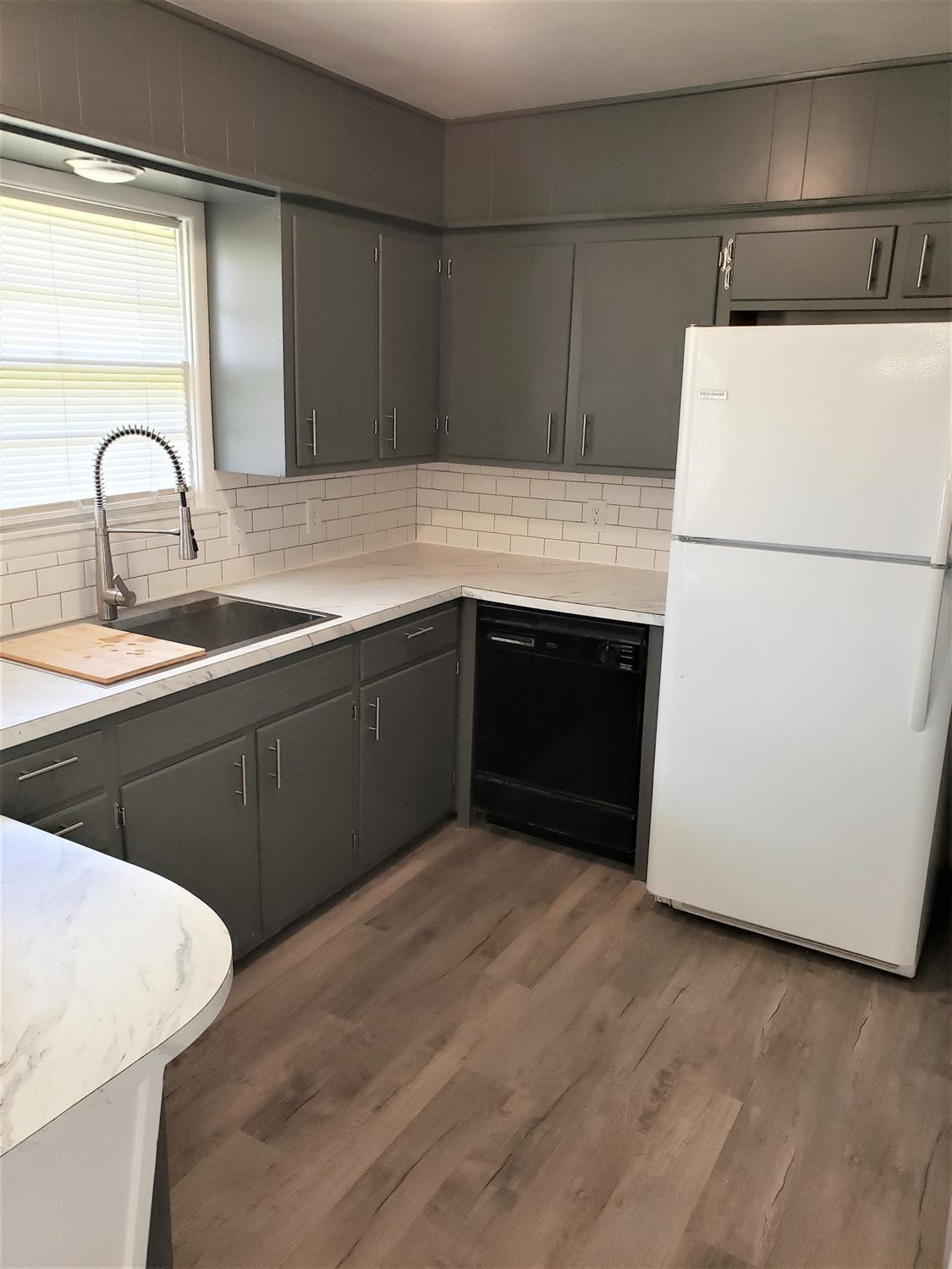 4906 6th Street Lubbock, TX 79416 - Photo 6 of 24 a kitchen with sink and white stainless steel appliances