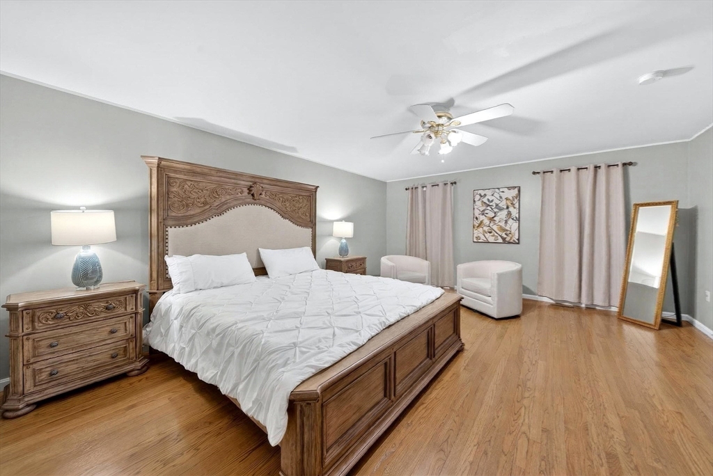 2 Hitching Post Lane Methuen, MA 01844 - Photo 18 of 40 a bedroom with a bed and a lamp with wooden floor