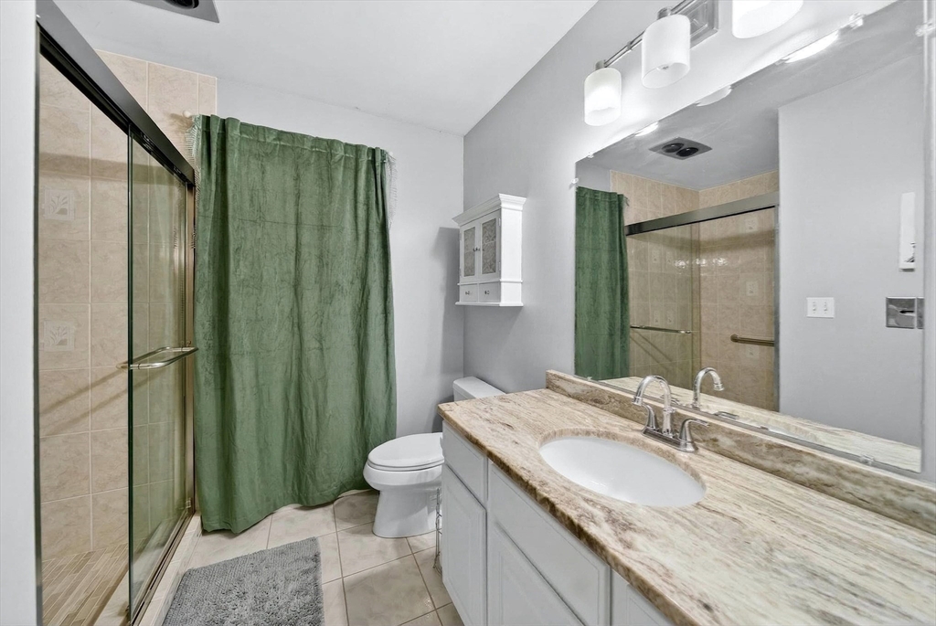 2 Hitching Post Lane Methuen, MA 01844 - Photo 20 of 40 a bathroom with a granite countertop sink a toilet a mirror and shower