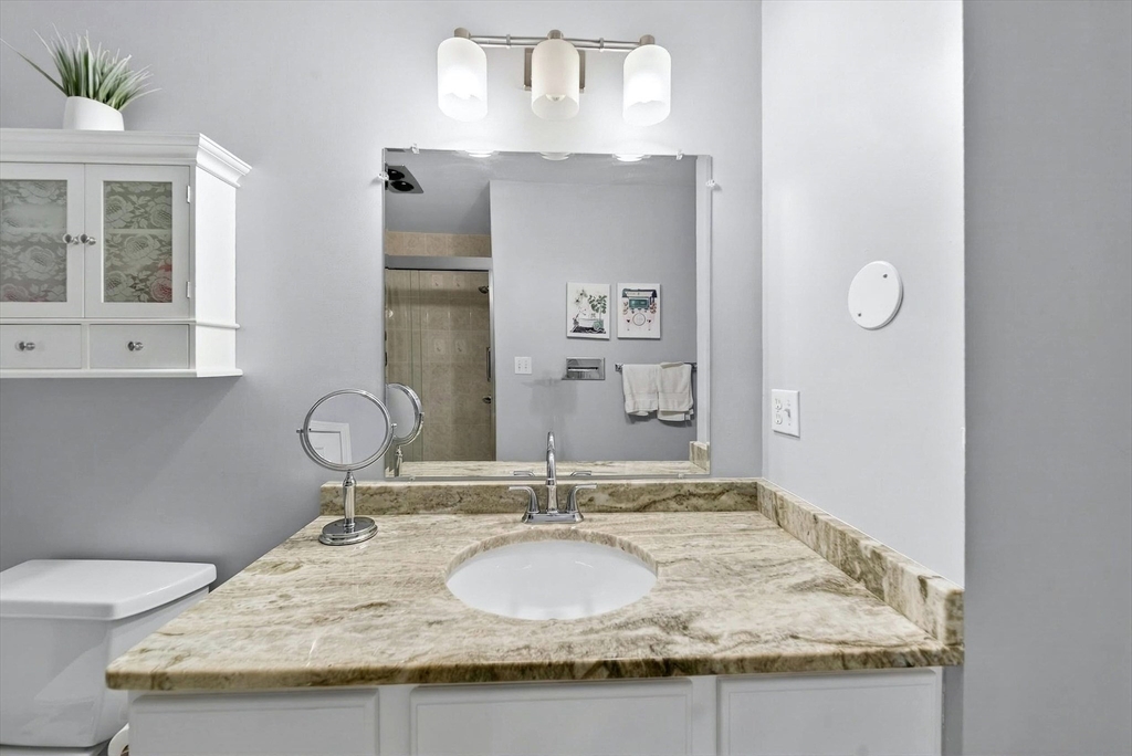 2 Hitching Post Lane Methuen, MA 01844 - Photo 21 of 40 a bathroom with a granite countertop sink and a mirror
