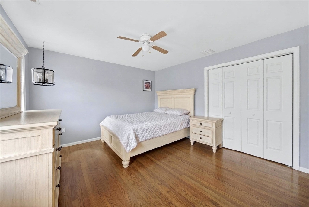 2 Hitching Post Lane Methuen, MA 01844 - Photo 25 of 40 a bedroom with a bed and a chandelier