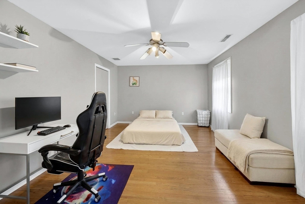 2 Hitching Post Lane Methuen, MA 01844 - Photo 31 of 40 a spacious bedroom with a bed and a chandelier