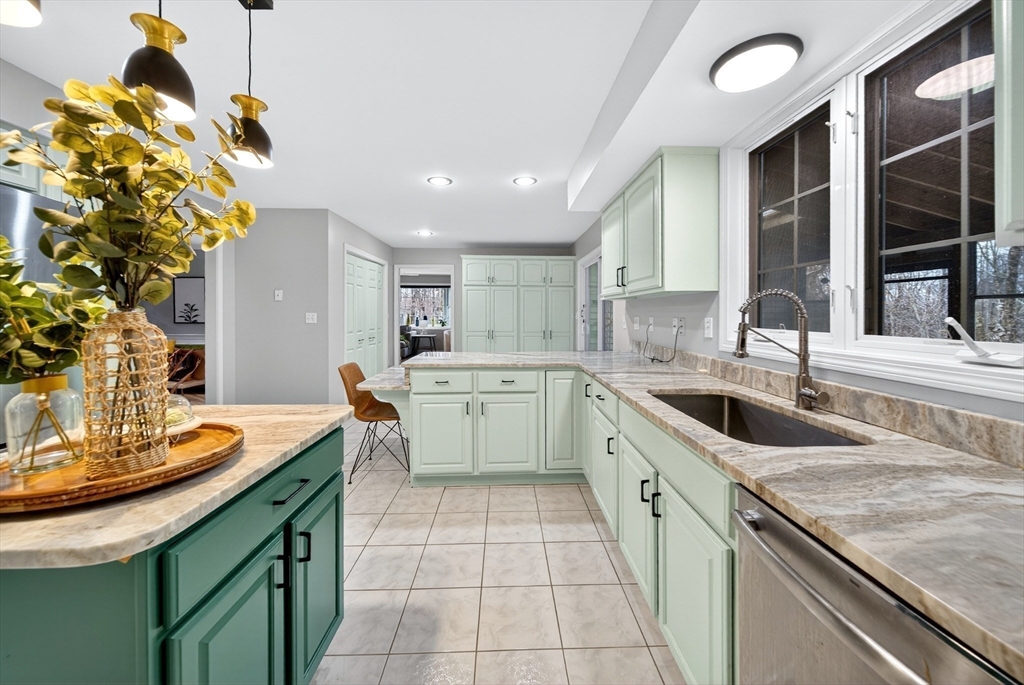2 Hitching Post Lane Methuen, MA 01844 - Photo 8 of 40 a kitchen with a sink stove and cabinets