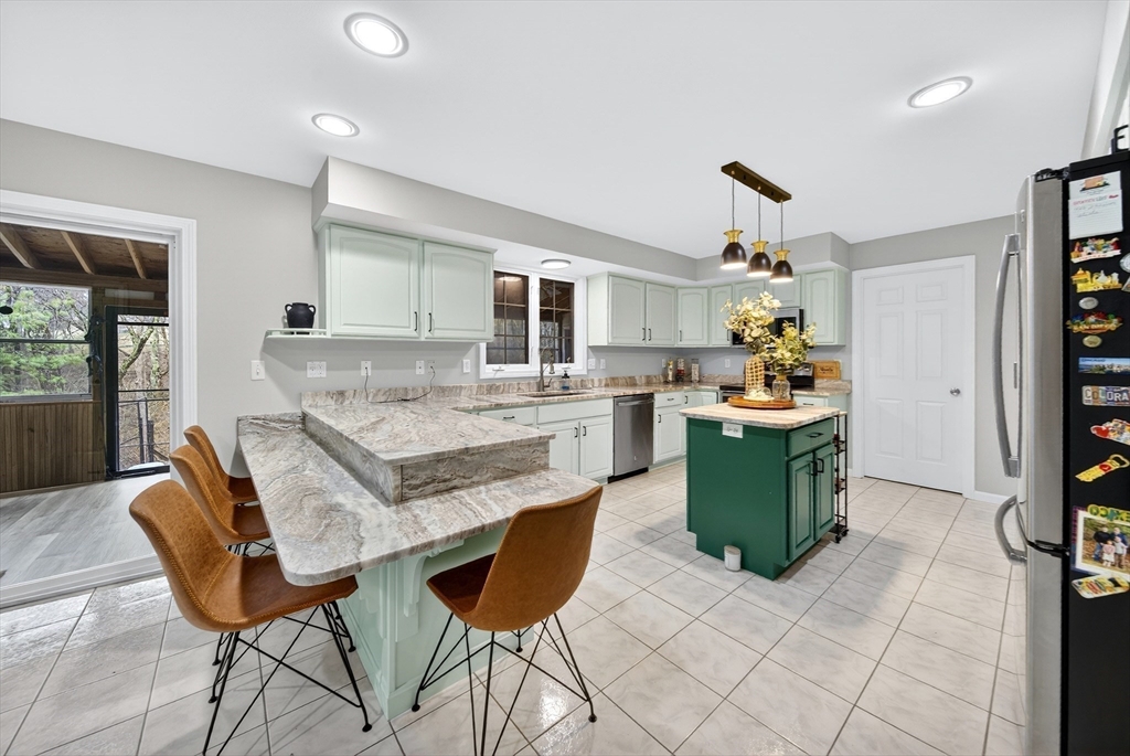 2 Hitching Post Lane Methuen, MA 01844 - Photo 9 of 40 a living room with granite countertop furniture and a fireplace
