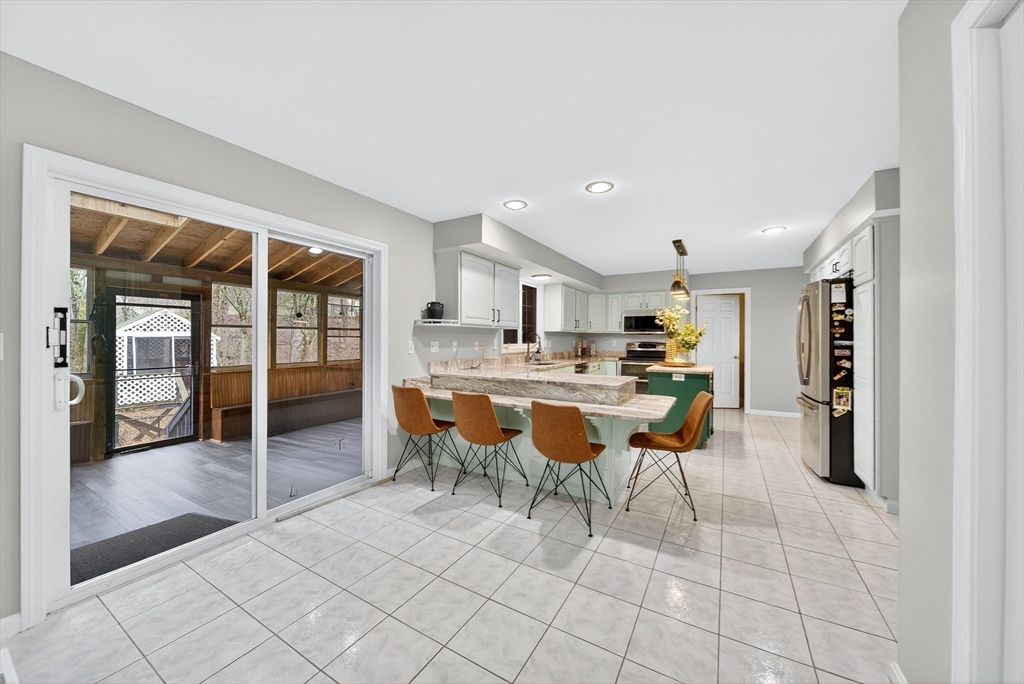 2 Hitching Post Lane Methuen, MA 01844 - Photo 10 of 40 a kitchen with stainless steel appliances kitchen island granite countertop a sink and cabinets