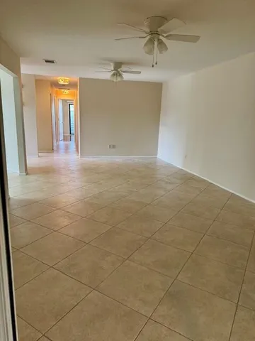 en empty room with windows and entrance