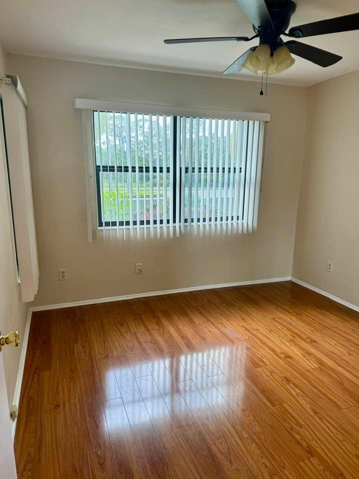 Undisclosed Address Port St. Lucie, FL 34952 - Photo 12 of 34 wooden floor in an empty room with a window