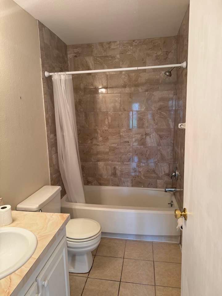 Undisclosed Address Port St. Lucie, FL 34952 - Photo 13 of 34 a bathroom with a granite countertop bathtub shower sink vanity and toilet