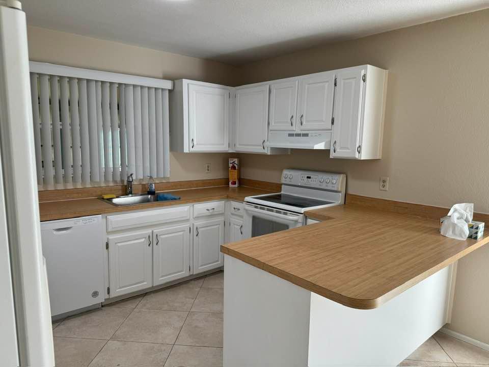 Undisclosed Address Port St. Lucie, FL 34952 - Photo 18 of 34 a kitchen that has a sink and a stove in it