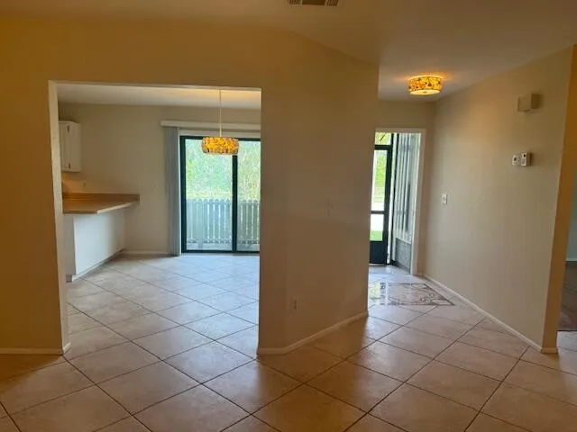 a kitchen with stainless steel appliances granite countertop a sink a stove a refrigerator and a window