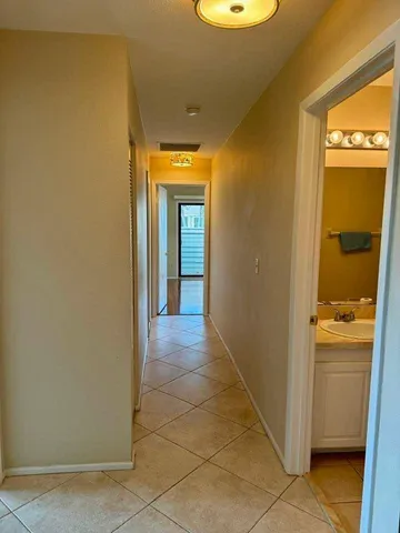 a view of a livingroom with wooden floor and a large window