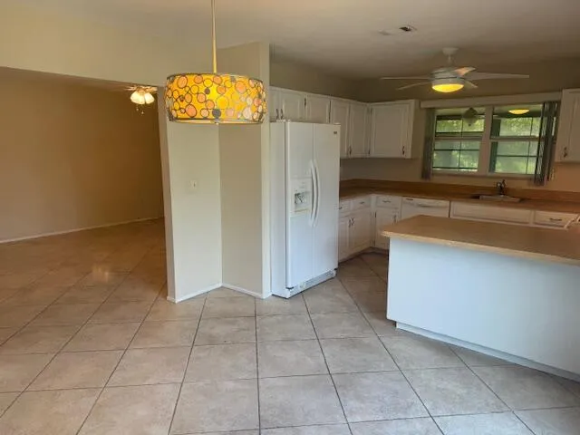 a view of a livingroom with wooden floor and a large window