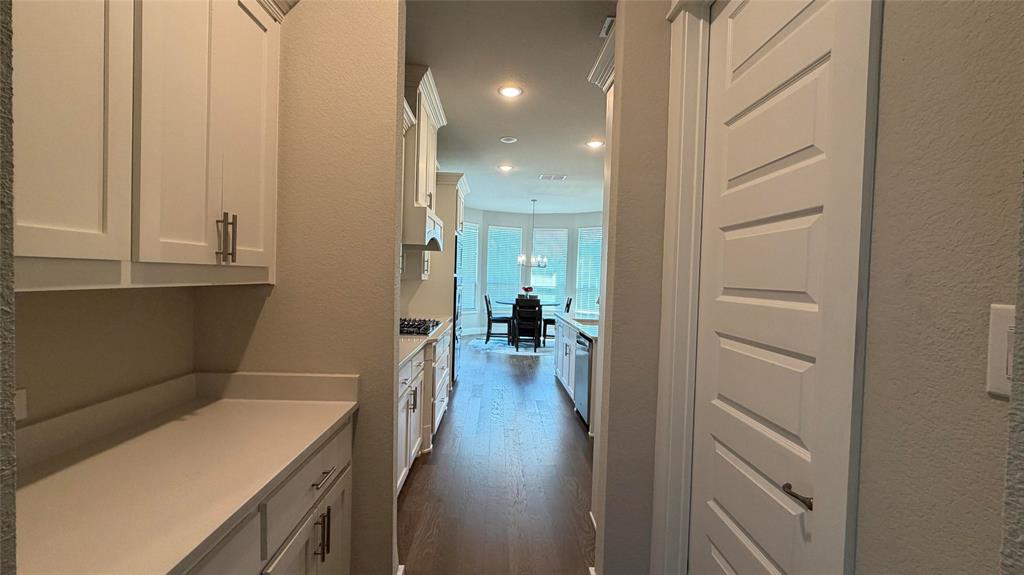 912 Fallbrook Avenue Denton, TX 76210 - Photo 22 of 26 a view of a hallway with wooden floor and closet