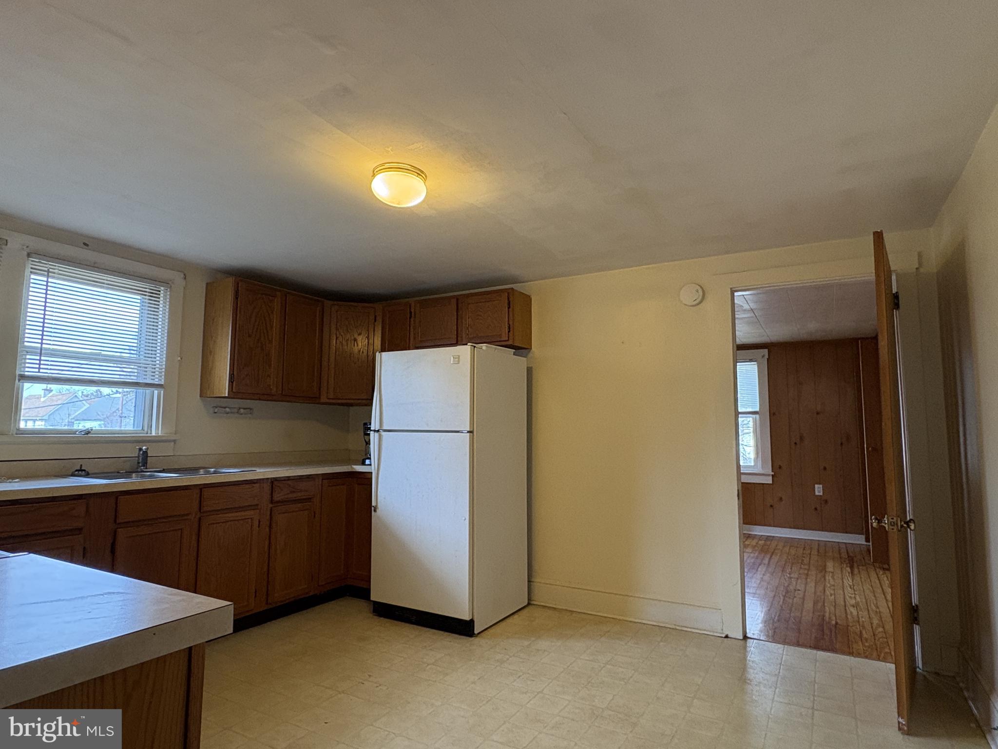 119 Maffitt Street, Unit 4 Elkton, MD 21921 - Photo 5 of 17 a view of a kitchen with a sink cabinets and a refrigerator