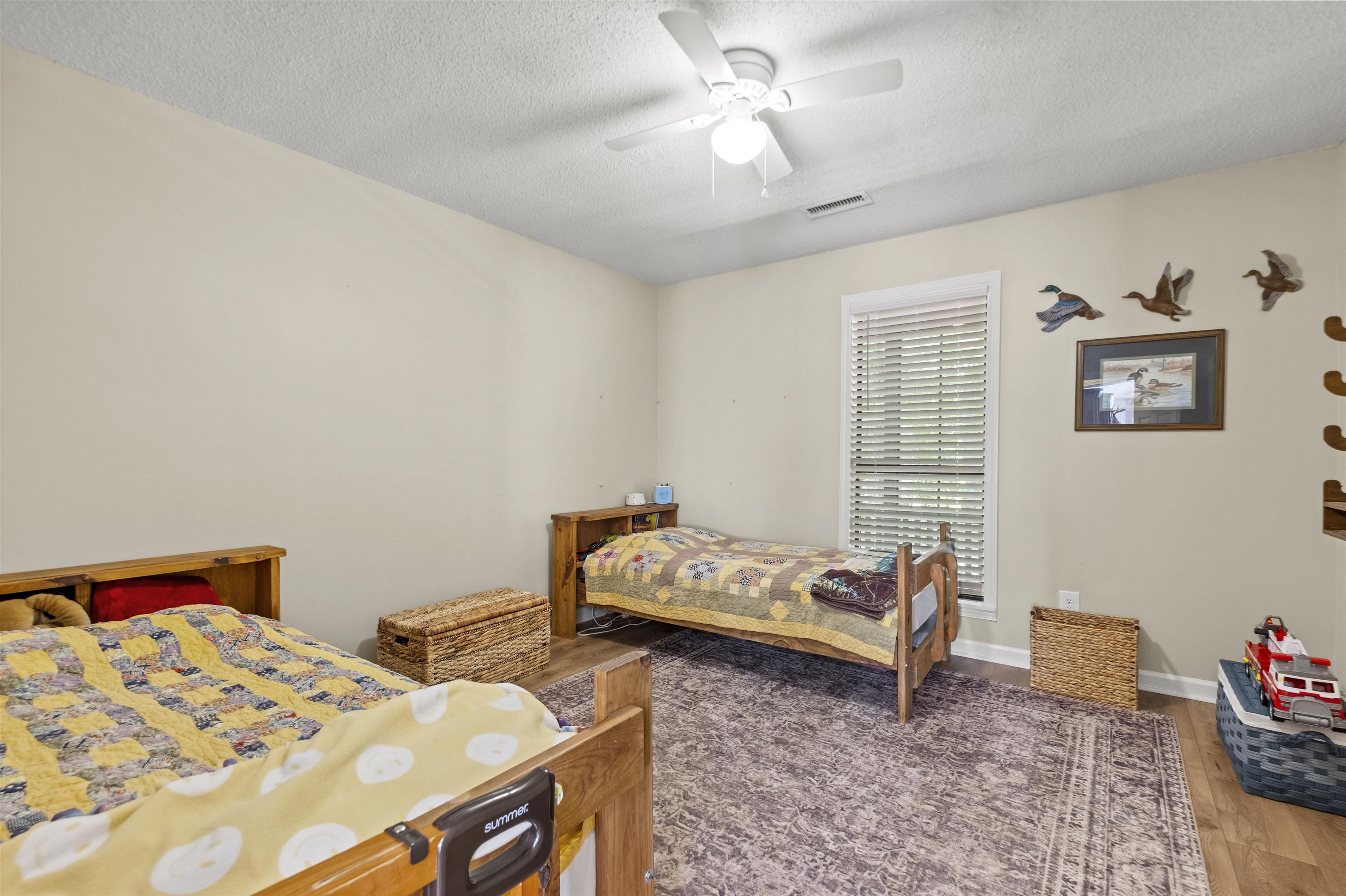 3601 Marshall Road Munford, TN 38058 - Photo 31 of 35 Bedroom featuring light-toned walls, a ceiling fan, and wood-finish flooring