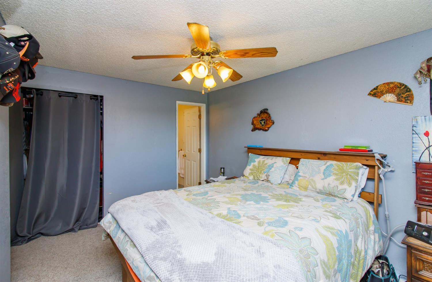 480 Elm Way Eagle Point, OR 97524 - Photo 12 of 26 a bedroom with a bed and a chandelier