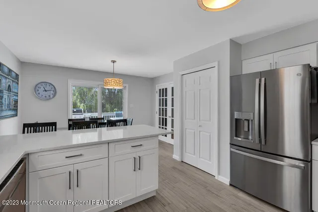 a kitchen with stainless steel appliances a refrigerator sink and cabinets