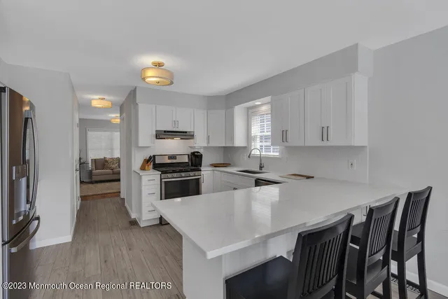a kitchen with a table chairs microwave and refrigerator