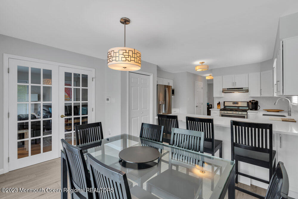 303 Salem Avenue Spring Lake, NJ 07762 - Photo 19 of 38 a dining room with furniture a chandelier and wooden floor