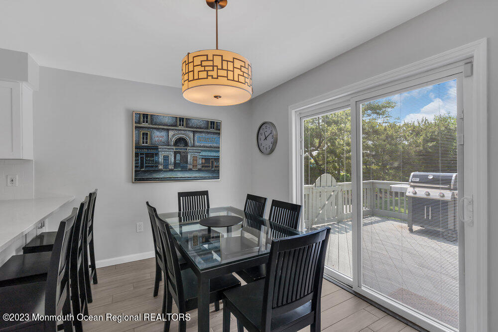 303 Salem Avenue Spring Lake, NJ 07762 - Photo 20 of 38 a view of a dining room with furniture wooden floor and a chandelier